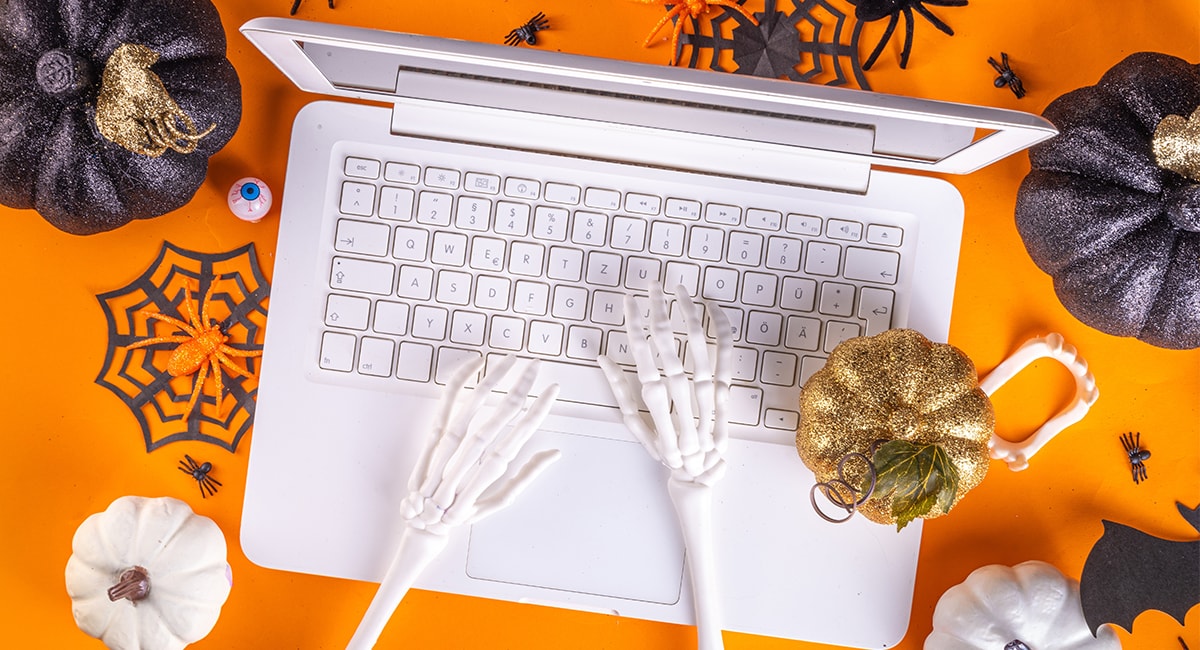 Skelton hands typing on laptop